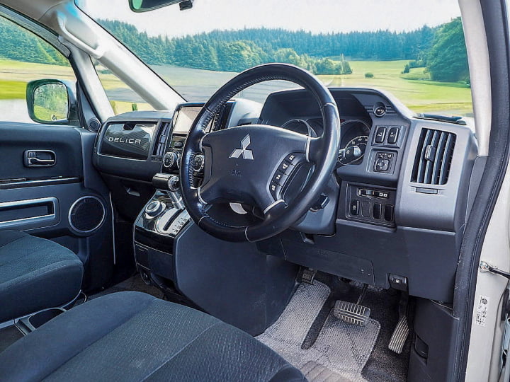 Driver seat and dashboard of Mitsubishi Delica D5 – functional and elevated cabin for Hokkaido rental drives